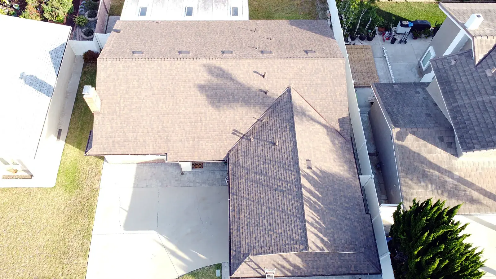 After: completed architectural shingle roof on the same Oxnard home, aerial view