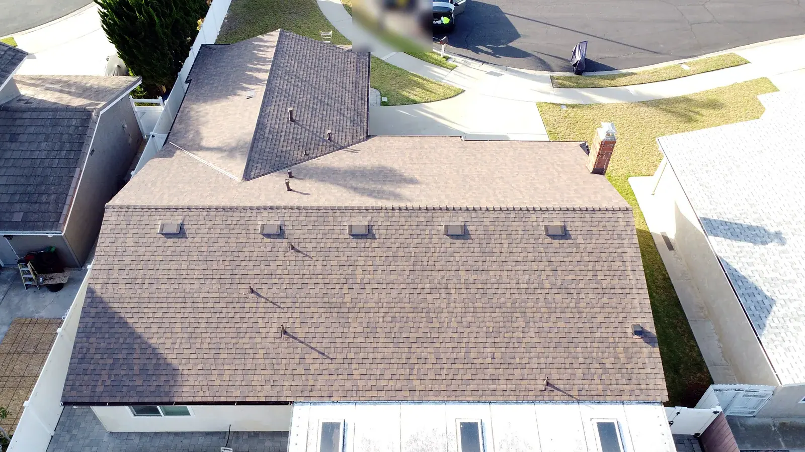 Front roof slope with new shingles and roof vents on an Oxnard single-story home